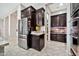 Well-organized kitchen with stainless steel fridge, plenty of cabinet space, and access to the pantry at 9388 W Cashman Dr, Peoria, AZ 85383