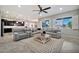 Bright living room featuring a plush sectional sofa, stylish coffee table, and views from the large bright windows at 9388 W Cashman Dr, Peoria, AZ 85383
