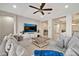Bright living room featuring a large TV, comfortable seating, and stylish décor at 9388 W Cashman Dr, Peoria, AZ 85383