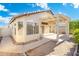 Charming backyard with a covered patio, landscaped yard, and walkway leading to the house at 10622 W Mohawk Ln, Peoria, AZ 85382