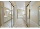 Bathroom hallway featuring a soaking tub and dual sinks creating a serene retreat at 10622 W Mohawk Ln, Peoria, AZ 85382