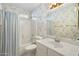 Cozy bathroom with a shower-tub combo and patterned wallpaper for a vintage look at 10622 W Mohawk Ln, Peoria, AZ 85382