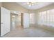 Empty bedroom with wood look tile flooring and access to other rooms at 10622 W Mohawk Ln, Peoria, AZ 85382