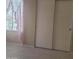 Bright bedroom features tile floors and a large sliding-door closet by a window at 10622 W Mohawk Ln, Peoria, AZ 85382