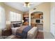 Staged bedroom featuring custom shelves, desk area and wood look tile flooring at 10622 W Mohawk Ln, Peoria, AZ 85382