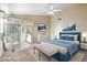 Serene and stylish staged primary bedroom filled with natural light and outdoor access at 10622 W Mohawk Ln, Peoria, AZ 85382