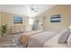 This primary bedroom offers a tranquil retreat with neutral colors, deck access and stylish decor at 10622 W Mohawk Ln, Peoria, AZ 85382