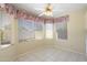 Cozy breakfast nook with floral valances, tile flooring, and backyard views at 10622 W Mohawk Ln, Peoria, AZ 85382
