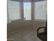 Cozy dining area featuring tile flooring, a corner window, and a comfortable office chair at 10622 W Mohawk Ln, Peoria, AZ 85382