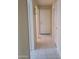 Hallway with tile flooring leading to multiple rooms and a light fixture at 10622 W Mohawk Ln, Peoria, AZ 85382