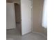 Hallway with neutral paint, tile floors, and paneled doors at 10622 W Mohawk Ln, Peoria, AZ 85382