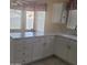 Bright kitchen with white cabinetry, ample countertop space, and a breakfast nook at 10622 W Mohawk Ln, Peoria, AZ 85382