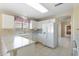 Well-lit kitchen featuring white cabinetry, marble countertops, and tile flooring at 10622 W Mohawk Ln, Peoria, AZ 85382