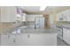 Bright kitchen with white cabinets, marble countertops, and stainless steel appliances at 10622 W Mohawk Ln, Peoria, AZ 85382