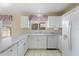 Bright kitchen featuring white cabinets, marble countertops, and modern appliances at 10622 W Mohawk Ln, Peoria, AZ 85382