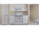 Modern kitchen with white appliances, ample storage, and marble countertops at 10622 W Mohawk Ln, Peoria, AZ 85382