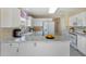 Virtually staged kitchen with white cabinets, marble countertops, and stainless steel appliances at 10622 W Mohawk Ln, Peoria, AZ 85382