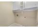 Bright laundry room featuring white cabinets above the machines for added storage at 10622 W Mohawk Ln, Peoria, AZ 85382