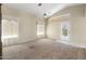 Bright living room with vaulted ceiling, transom windows, and door leading to the backyard at 10622 W Mohawk Ln, Peoria, AZ 85382