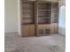 Living room boasts a large, wooden built-in bookcase with cabinets for ample storage at 10622 W Mohawk Ln, Peoria, AZ 85382