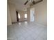 Spacious living room features neutral walls, tile flooring, and seamless transition to carpeted area at 10622 W Mohawk Ln, Peoria, AZ 85382
