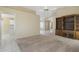 Open living space with carpet and tile flooring, ceiling fan, and built-in bookcase at 10622 W Mohawk Ln, Peoria, AZ 85382
