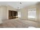 Bright living area with carpet and built-in bookcase, and lots of natural light at 10622 W Mohawk Ln, Peoria, AZ 85382