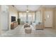 Staged living room with neutral furniture, bright pillows, and tile flooring at 10622 W Mohawk Ln, Peoria, AZ 85382