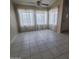 Bright living room featuring tile flooring, neutral walls, and abundant natural light from multiple windows at 10622 W Mohawk Ln, Peoria, AZ 85382