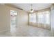Open-concept living room featuring bright floor tiles and a view of the kitchen area at 10622 W Mohawk Ln, Peoria, AZ 85382