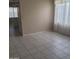 Spacious living room area featuring tile floors, natural light, and neutral paint tones at 10622 W Mohawk Ln, Peoria, AZ 85382