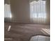 Spacious carpeted living room with large windows and natural light, a comfortable and inviting space at 10622 W Mohawk Ln, Peoria, AZ 85382