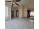 Open-concept living room with tile flooring flowing into carpeted area and views into other rooms at 10622 W Mohawk Ln, Peoria, AZ 85382
