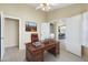 Bright office area furnished with a wooden desk, leather chair, and artwork on the wall at 10622 W Mohawk Ln, Peoria, AZ 85382