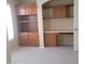 Cozy office space with built-in shelving, cabinets, a workspace, and tile flooring at 10622 W Mohawk Ln, Peoria, AZ 85382