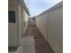 Narrow side yard featuring decorative rock landscaping and concrete walkway leading to the backyard at 10622 W Mohawk Ln, Peoria, AZ 85382