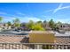 A view from a balcony across townhomes, with tile roofs, private garages, and mature trees at 11000 N 77Th Pl # 2032, Scottsdale, AZ 85260