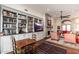 Living room with a stone fireplace, built-in shelving, and a dining area at 11067 E Juan Tabo Rd, Scottsdale, AZ 85255