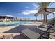 Community swimming pool with lounge chairs under umbrellas for residents of a planned community at 1185 W Sparrow Dr, Queen Creek, AZ 85140