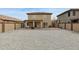 Backyard with gravel, patio with seating, and a block wall at 12054 W Aster W Dr, El Mirage, AZ 85335