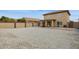 Backyard featuring a gravel area, covered patio, and a privacy wall at 12054 W Aster W Dr, El Mirage, AZ 85335