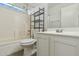 Bathroom featuring a shower over tub, black metal shelf, and white vanity at 12054 W Aster W Dr, El Mirage, AZ 85335