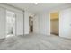 Spacious bedroom with plush carpet, multiple doorways, including access to a bathroom and closet at 12054 W Aster W Dr, El Mirage, AZ 85335