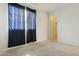 Bedroom with plush carpeting, closet, and a window letting in natural light at 12054 W Aster W Dr, El Mirage, AZ 85335