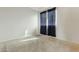 Bright bedroom with plush carpeting, a window with blinds, and a modern aesthetic at 12054 W Aster W Dr, El Mirage, AZ 85335