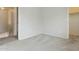 Comfortable carpeted bedroom featuring neutral walls, a closet, and an open doorway at 12054 W Aster W Dr, El Mirage, AZ 85335