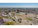 Aerial view of a community home backing up to a lush green golf course at 13913 W Whitewood Dr, Sun City West, AZ 85375