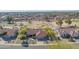 Expansive aerial shot of a home with a red tile roof in a golf course community with mature landscaping at 13913 W Whitewood Dr, Sun City West, AZ 85375