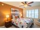 Inviting bedroom with a cozy bed, shuttered windows, and warm lighting at 13913 W Whitewood Dr, Sun City West, AZ 85375