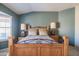 Comfortable bedroom featuring a rustic wood bed frame, and warm, inviting decor at 13913 W Whitewood Dr, Sun City West, AZ 85375